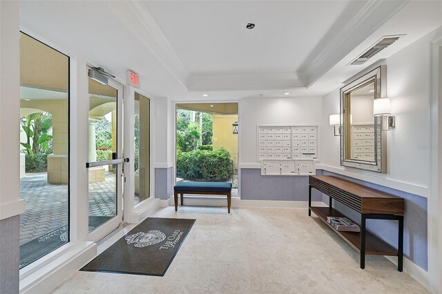 sitting room featuring crown molding, a raised ceiling, and mail boxes