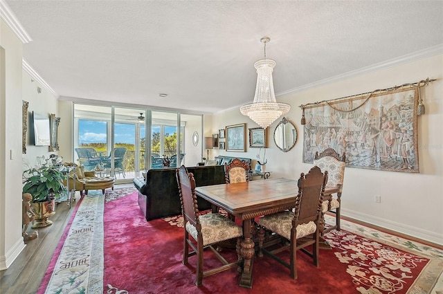 dining area featuring a textured ceiling, ornamental molding, hardwood / wood-style floors, and a notable chandelier