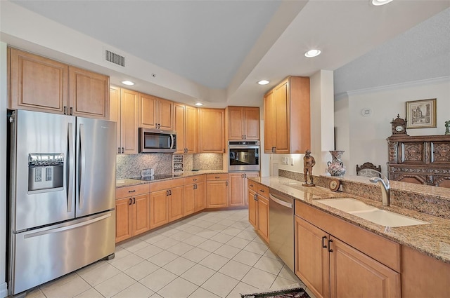 kitchen with light tile patterned floors, appliances with stainless steel finishes, light stone counters, sink, and ornamental molding