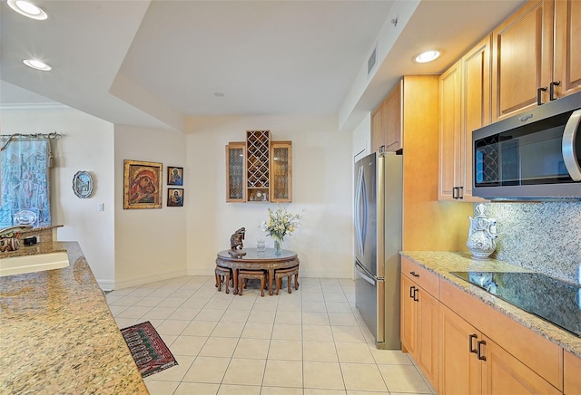 kitchen featuring light stone counters, stainless steel appliances, sink, and light tile patterned floors