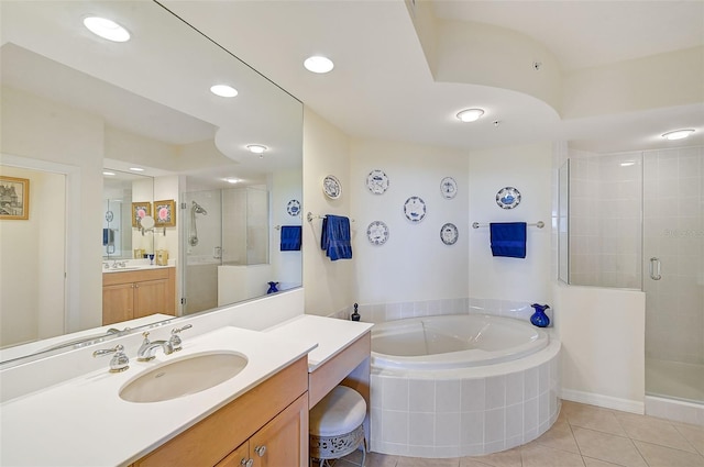 bathroom featuring shower with separate bathtub, vanity, and tile patterned floors