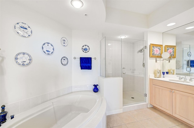 bathroom with tile patterned floors, shower with separate bathtub, and vanity