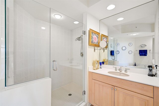 bathroom featuring an enclosed shower and vanity