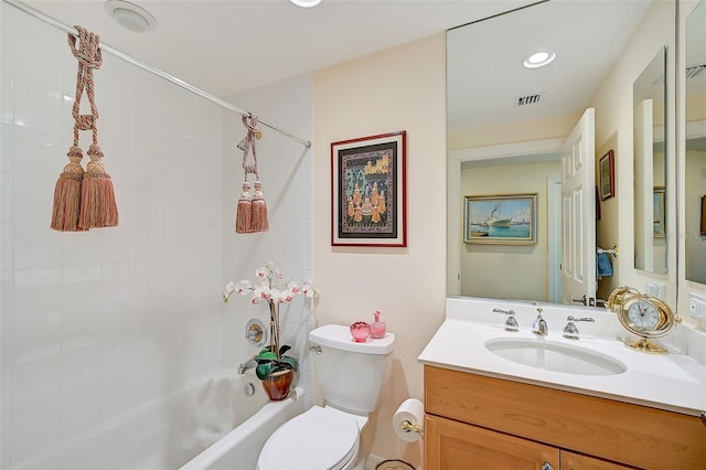 full bathroom with tiled shower / bath, vanity, and toilet