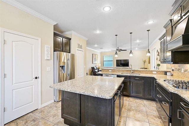 kitchen featuring light stone countertops, premium range hood, a sink, stainless steel appliances, and backsplash