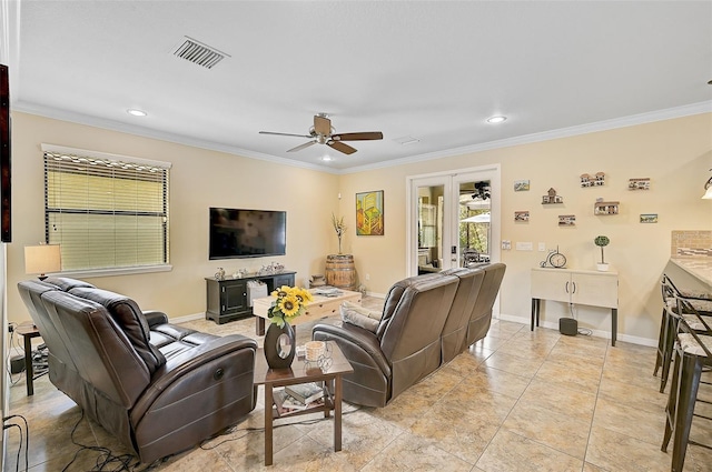 living room featuring visible vents, baseboards, crown molding, and ceiling fan