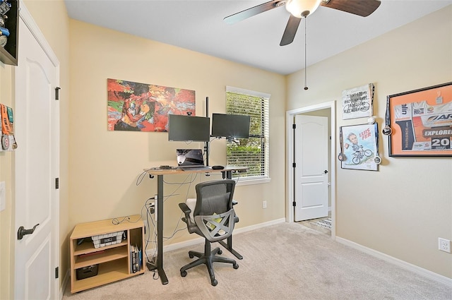 carpeted office with baseboards and ceiling fan