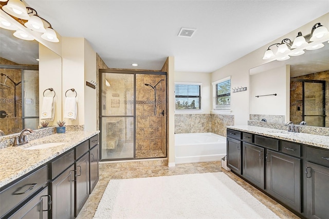 bathroom with a bath, visible vents, a shower stall, and a sink