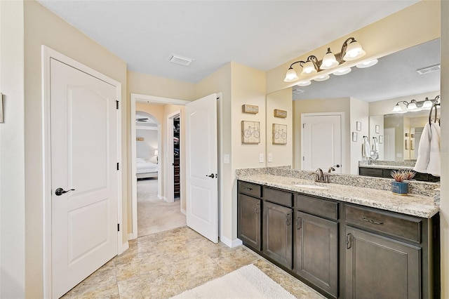 full bathroom with visible vents, vanity, and baseboards