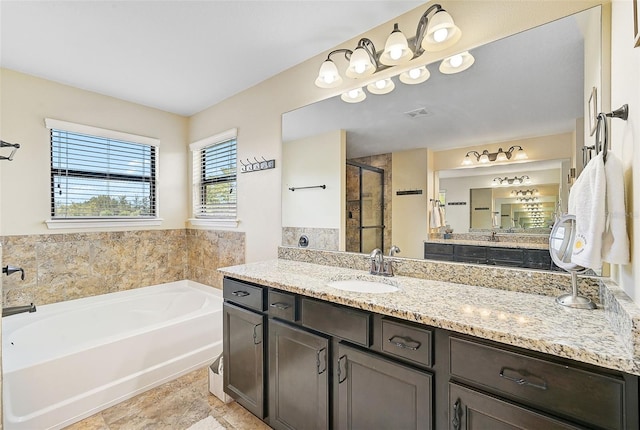 bathroom with visible vents, vanity, a garden tub, and a shower stall