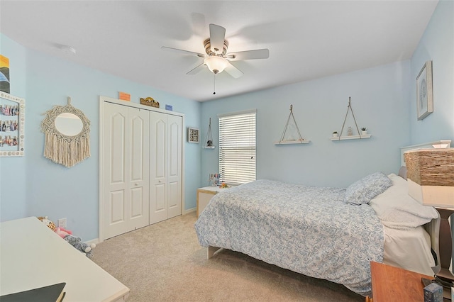 bedroom with a closet, light carpet, baseboards, and a ceiling fan