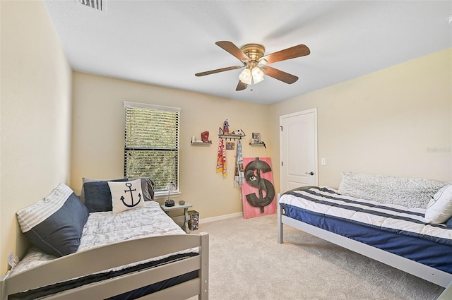 carpeted bedroom featuring visible vents, ceiling fan, and baseboards