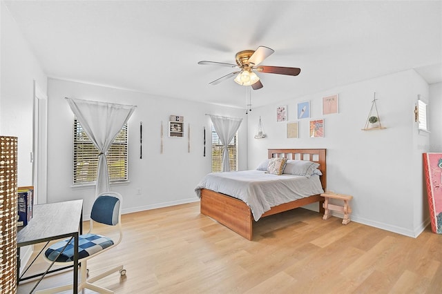 bedroom featuring light wood-style flooring, baseboards, and ceiling fan