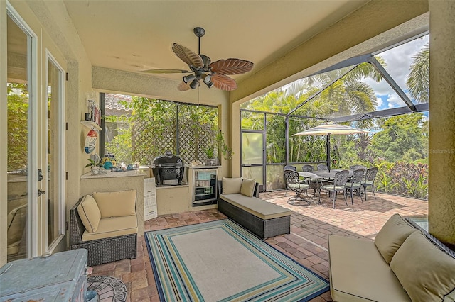 view of patio with a lanai, outdoor dining space, outdoor lounge area, and exterior kitchen