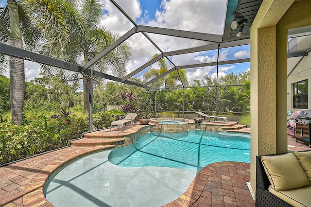 view of pool featuring glass enclosure, a patio, area for grilling, and a pool with connected hot tub