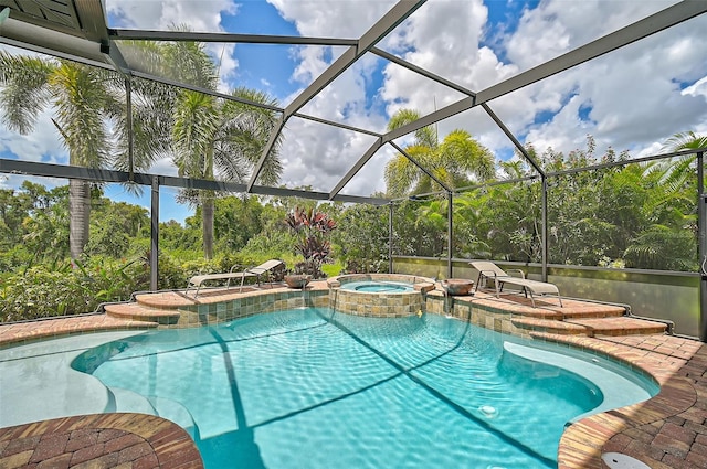 view of swimming pool with a lanai, a patio area, and a pool with connected hot tub