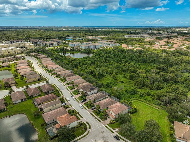 drone / aerial view with a residential view and a water view