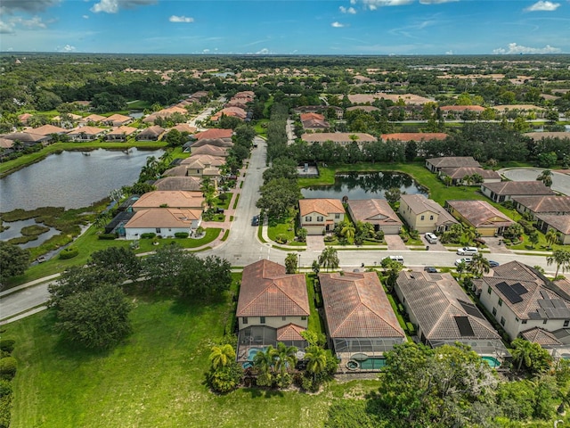 drone / aerial view with a residential view and a water view