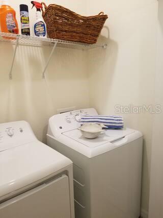 clothes washing area with washing machine and clothes dryer