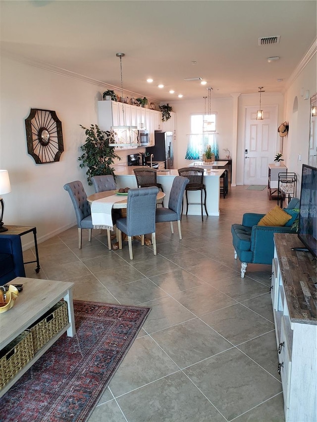 tiled dining area featuring crown molding