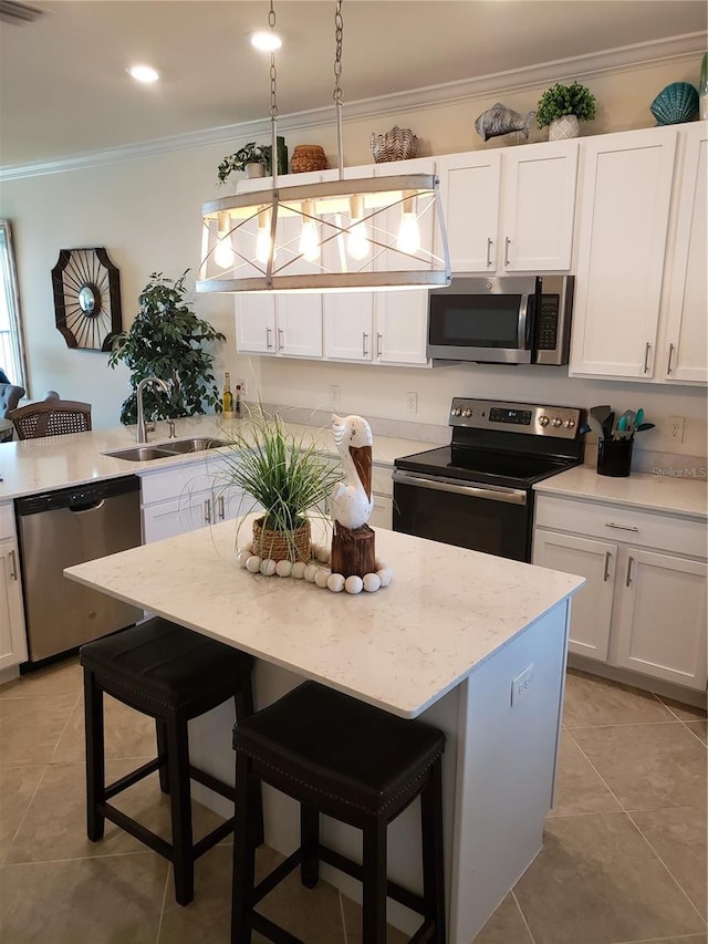 kitchen featuring sink, white cabinetry, a center island, and stainless steel appliances