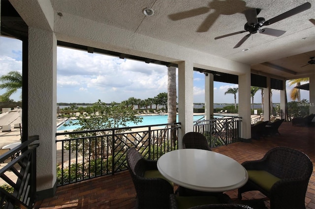 exterior space featuring ceiling fan