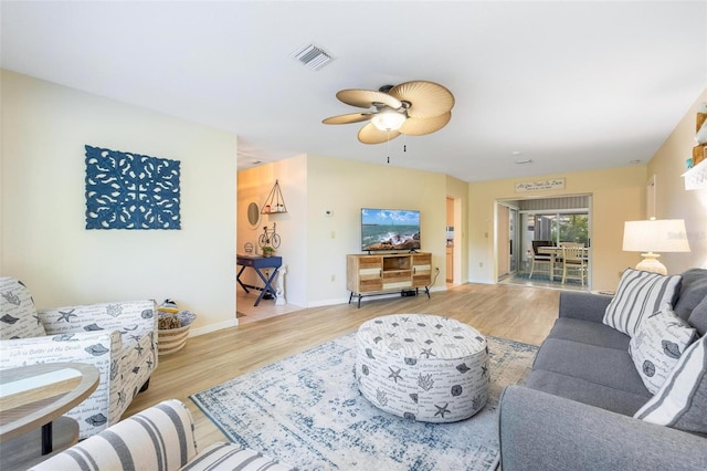 living room featuring ceiling fan and light wood-type flooring