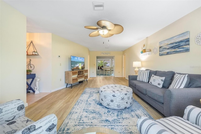 living room featuring ceiling fan and light hardwood / wood-style floors