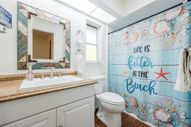 bathroom featuring a shower with shower curtain, wood-type flooring, toilet, and vanity