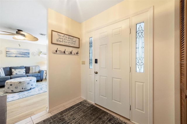 tiled entrance foyer with ceiling fan