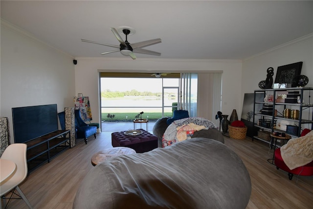 living room featuring ornamental molding, hardwood / wood-style flooring, and ceiling fan