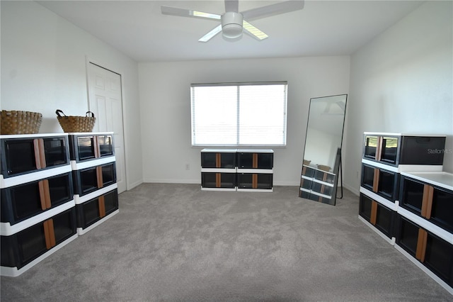 sitting room featuring ceiling fan and carpet flooring