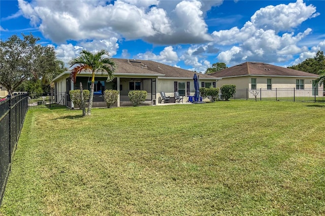 back of house with a patio area and a lawn