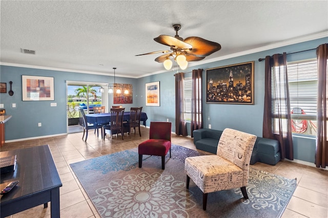 living room featuring ceiling fan with notable chandelier, a textured ceiling, crown molding, and light tile patterned flooring