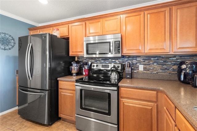 kitchen with light tile patterned floors, backsplash, crown molding, and stainless steel appliances