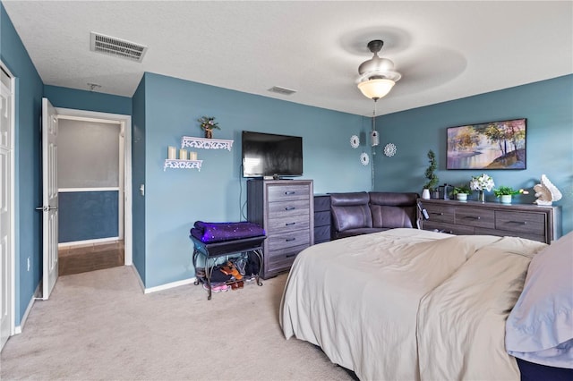 bedroom featuring ceiling fan and light carpet