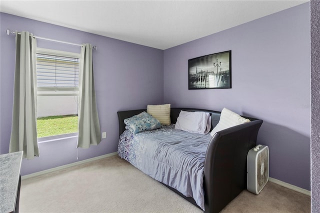 bedroom featuring light colored carpet