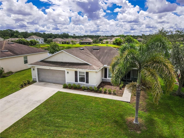 ranch-style house featuring a front yard and a garage