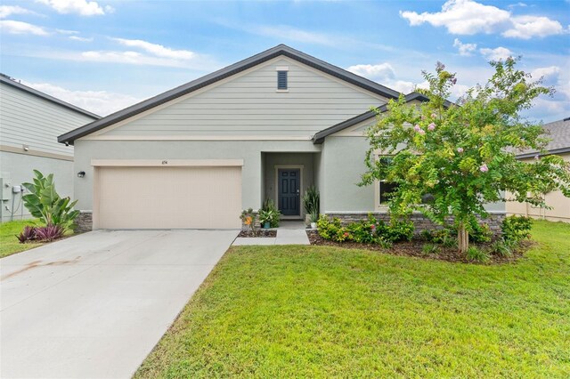 view of front of house featuring a garage and a front yard