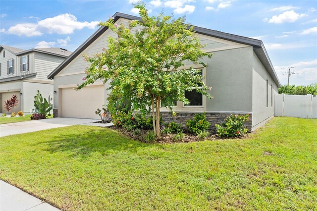 view of front facade with a garage and a front lawn