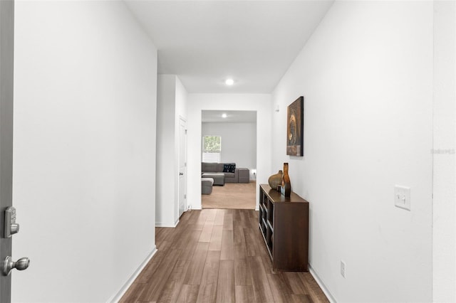 hall with wood finished floors and baseboards