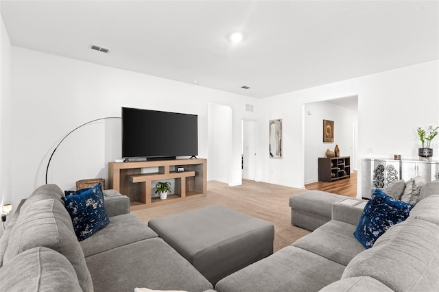 carpeted living room featuring visible vents