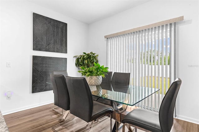 dining area featuring wood finished floors and baseboards