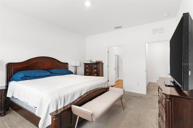 bedroom featuring light carpet, visible vents, and baseboards