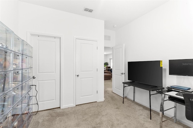 carpeted home office with visible vents and baseboards