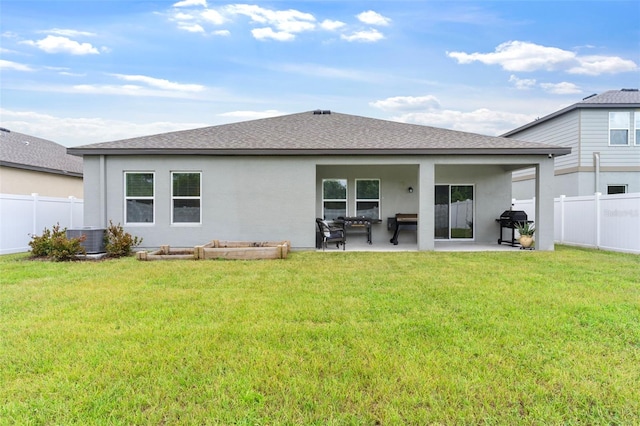 back of house with a yard, a patio, a fenced backyard, and stucco siding