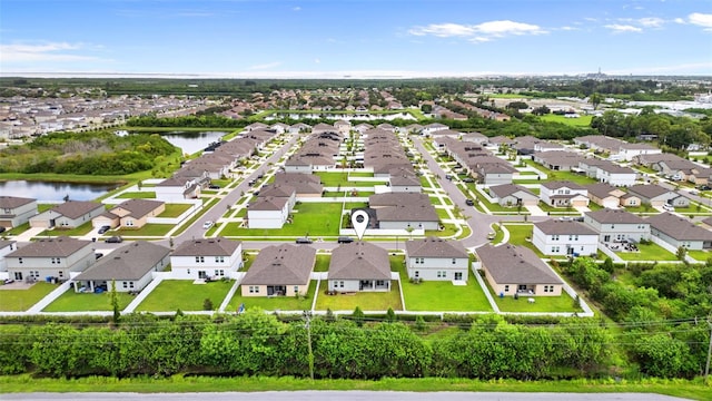 drone / aerial view featuring a water view and a residential view