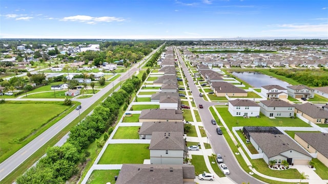 birds eye view of property with a residential view and a water view