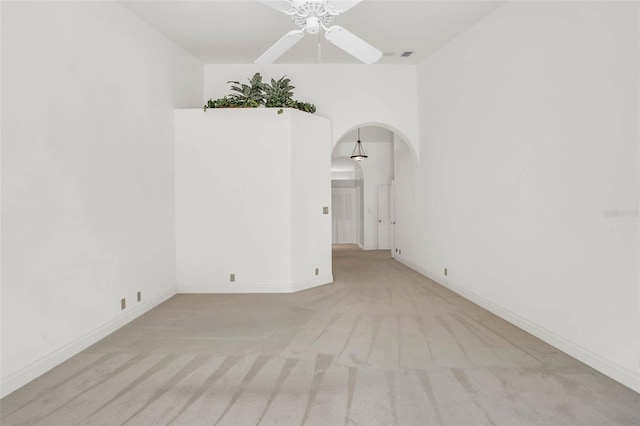 empty room with ceiling fan and light colored carpet