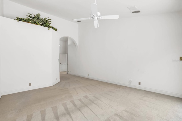 carpeted empty room featuring ceiling fan